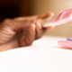 Black person with pregnancy test